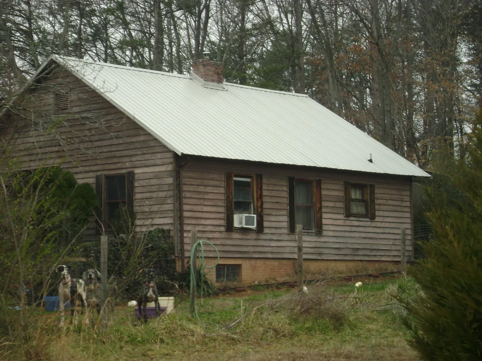 White metal roof on an old wood sided farmhouse, from a Metal Roof Installation job in Upton